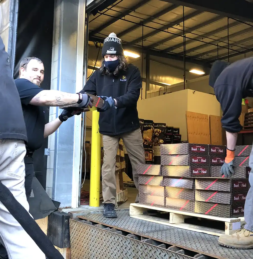 Volunteers at The Pantry carrying items out of the truck