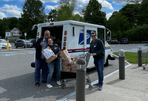 Stamp Out Hunger mail truck and letter carriers